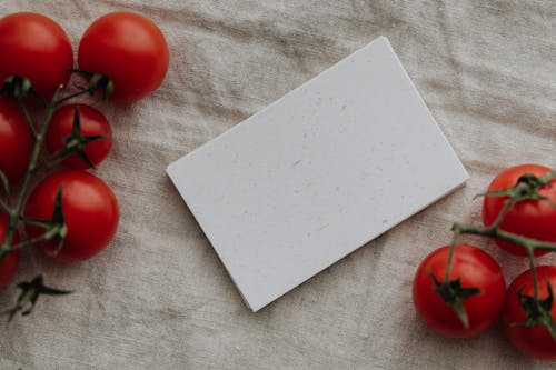 Photo Of Tomatoes Near Blank Papers