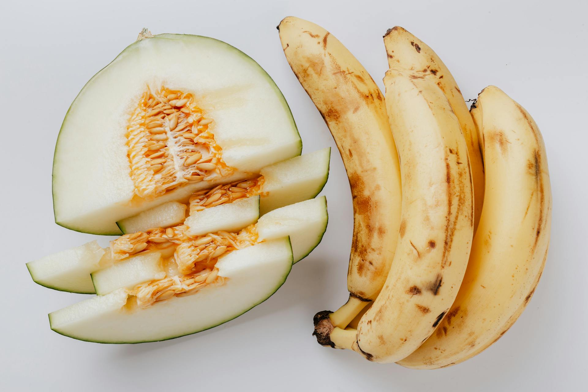 Photo Of Banana Beside Sliced Melon