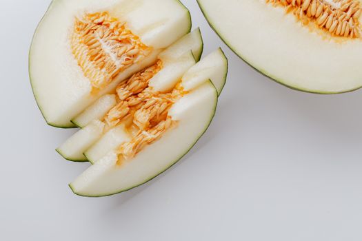 Close-up of fresh honeydew melon slices showcasing tasty seeds and vibrant texture.