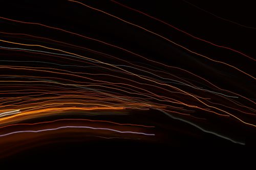 Free Vibrant abstract light trails create a dynamic visual effect on a dark background. Stock Photo