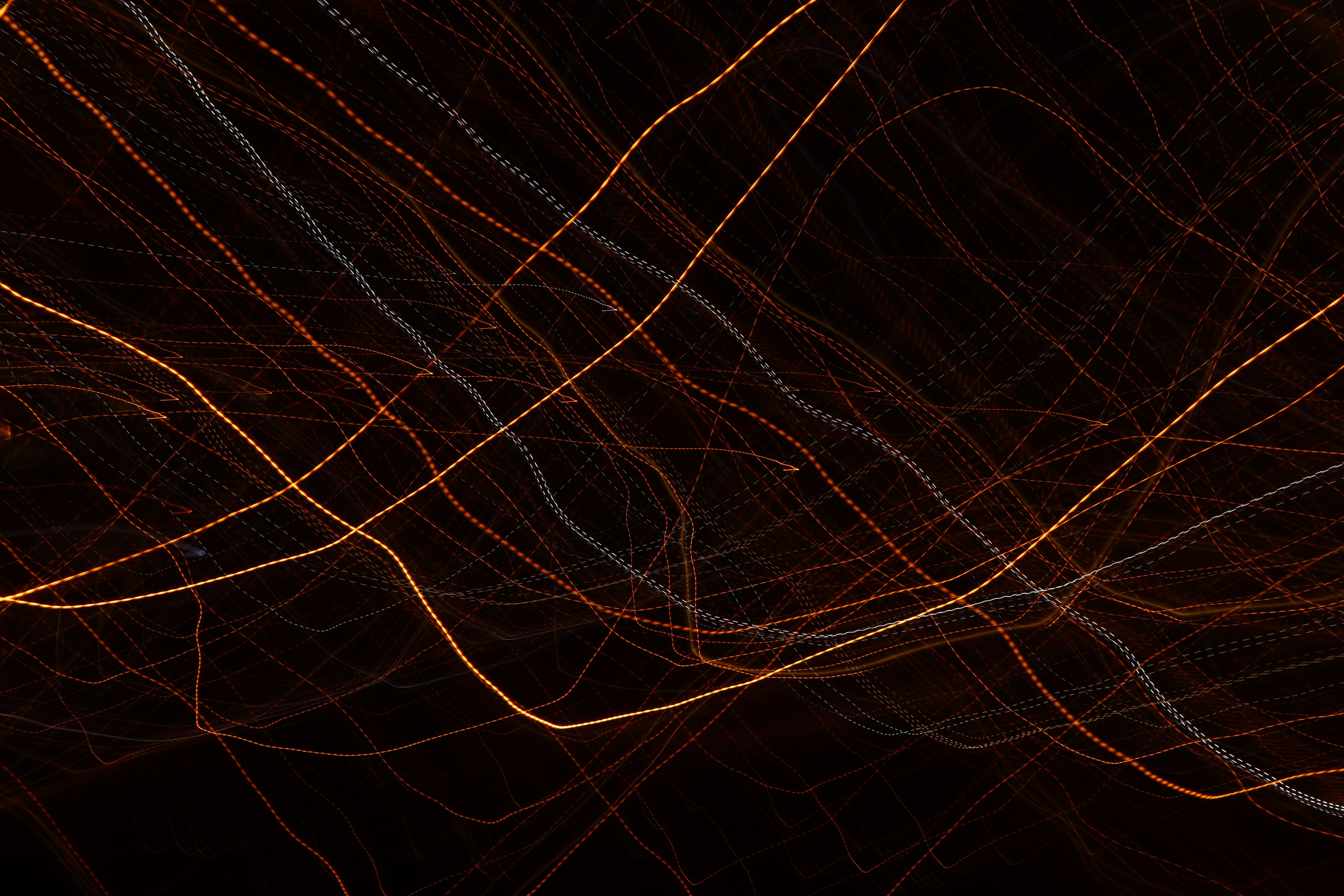 Abstract lines of light create dynamic patterns against a dark background.