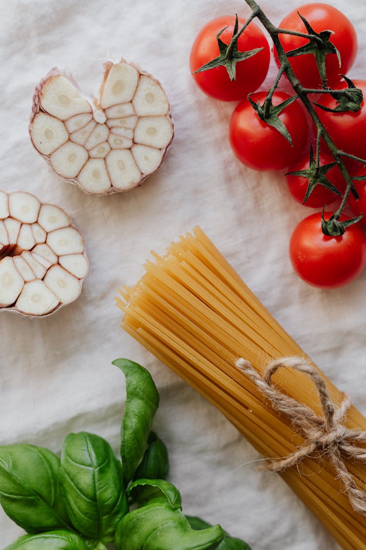 Photo Of Cherry Tomatoes Beside Sliced Garlic