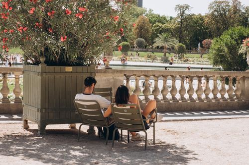 Free A couple enjoys a peaceful moment in Jardin du Luxembourg, Paris. Stock Photo