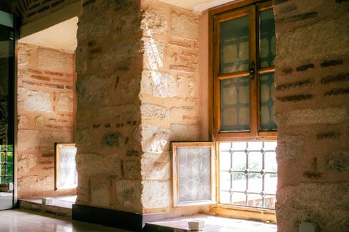 Free Warm light streaming through windows in a historic stone building interior, showcasing traditional architecture. Stock Photo