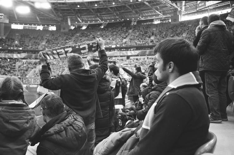 Spectators Watching Match On Large Stadium