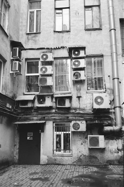Air conditioners on old building in backyard