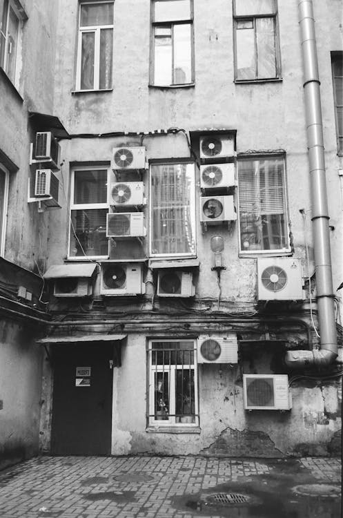 Air conditioners on old building in backyard