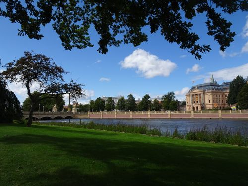 Free A picturesque view of Schwerin Palace by the lake on a sunny summer day, showcasing its stunning architecture. Stock Photo