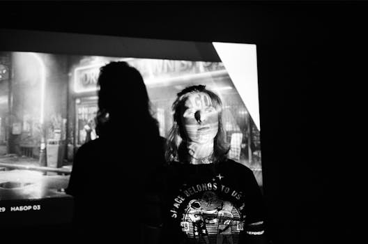 A striking black and white projection creates a vintage silhouette effect on a person indoors.