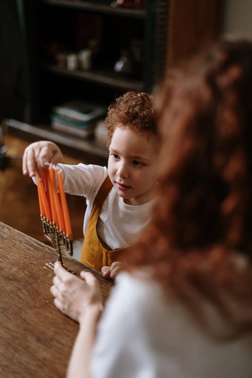 Free Child Touching a Menorah Stock Photo