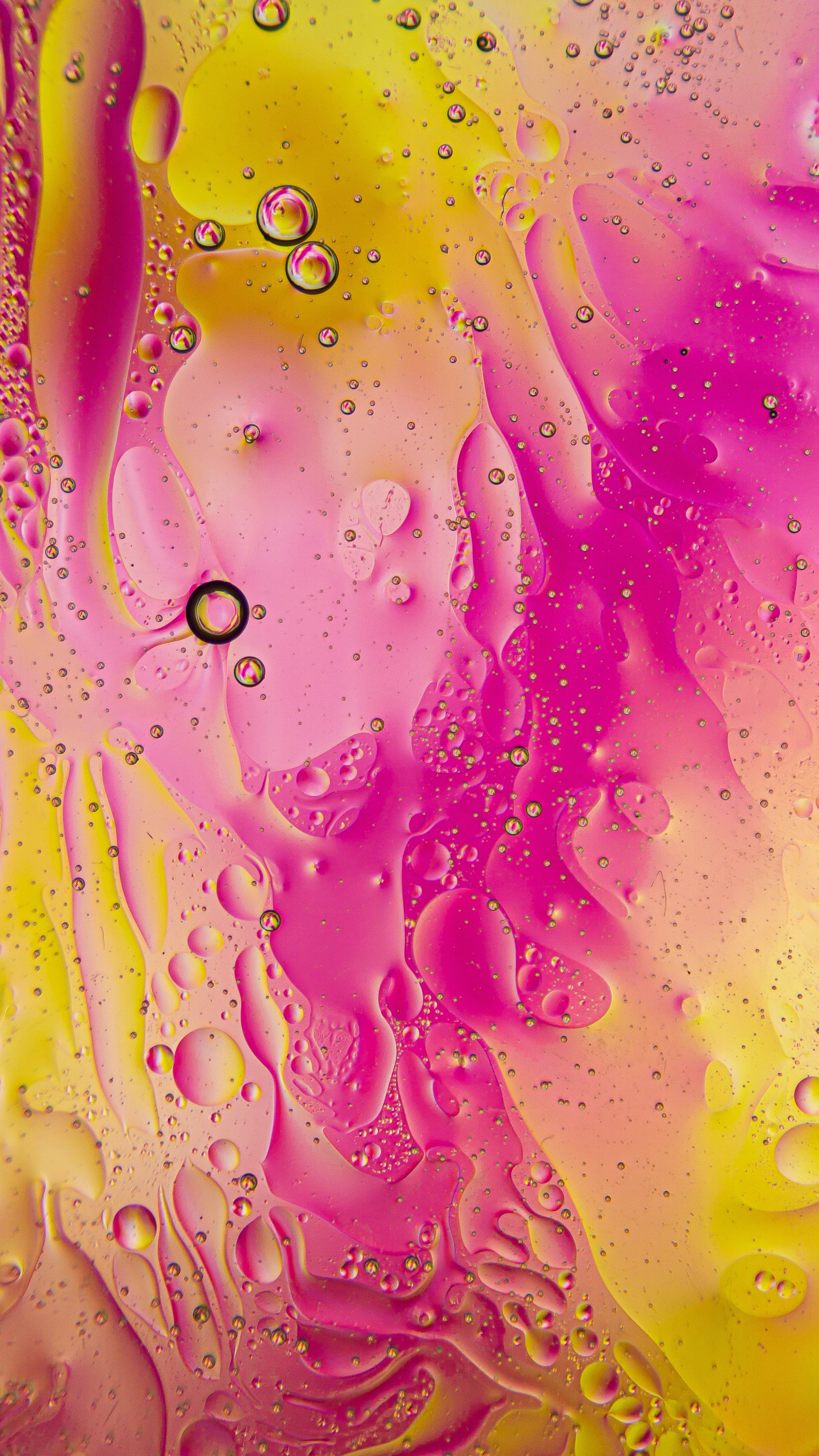 Fotomural Imagen abstracta y colorida con texturas de aceite y agua en tonos rosas y amarillos. Ideal para fondos creativos.