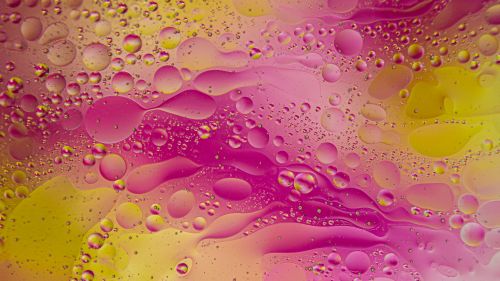 Free A colorful abstract image of oil and water mixture creating a vibrant pattern. Stock Photo