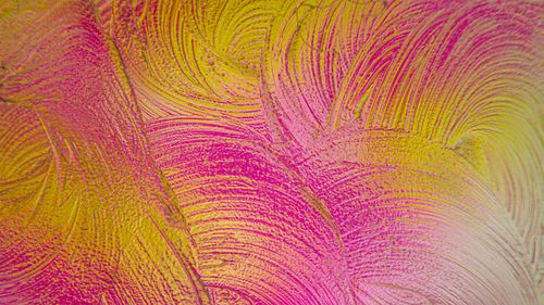 Free Colorful abstract texture with swirling pink and yellow paint strokes creating an artistic and vibrant pattern. Stock Photo
