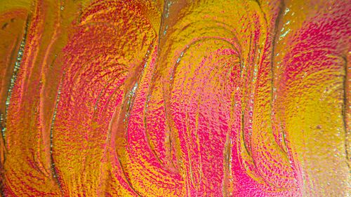 Free A colorful abstract artwork featuring swirling pink and yellow patterns, creating a dynamic visual effect. Stock Photo
