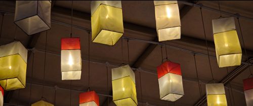 Free Glowing paper lanterns hanging from the ceiling create a warm indoor ambiance. Stock Photo