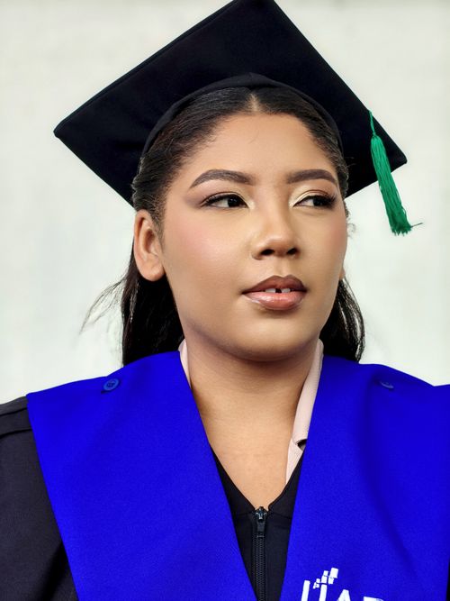 Free Portrait of a young woman in graduation cap and gown, symbolizing achievement. Stock Photo