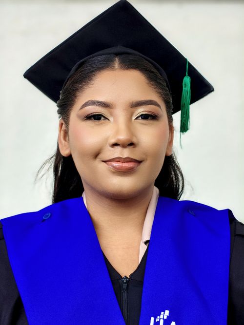Free Confident graduate poses in traditional cap and gown, celebrating academic achievement. Stock Photo