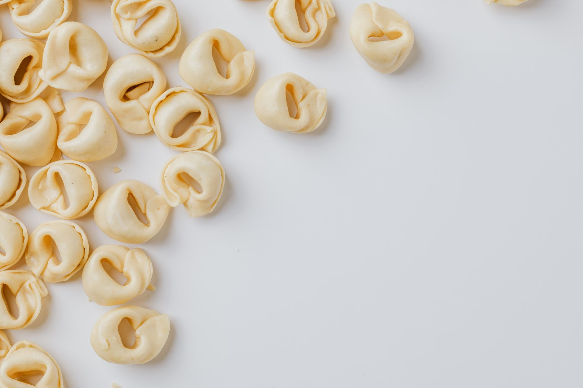 Freshly grated Parmesan cheese and chicken tortellini soup ready to serve