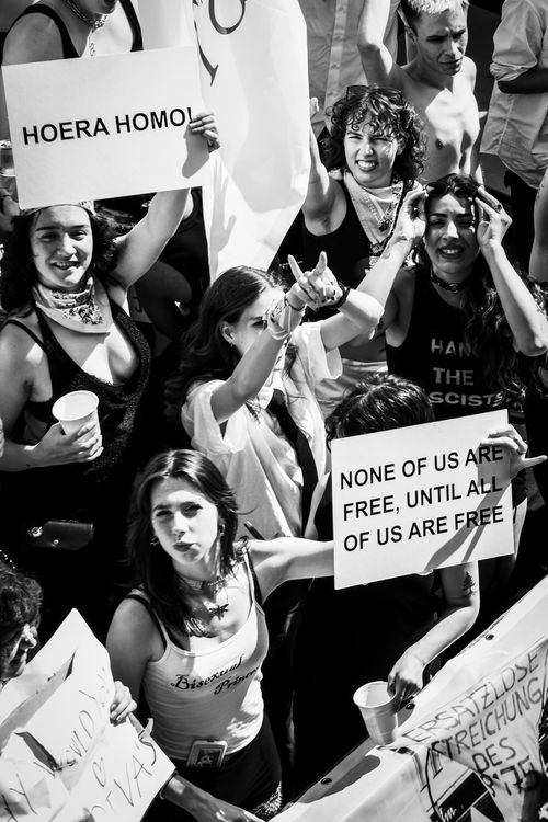 Free Powerful LGBT rights protest in Amsterdam with diverse group and signs advocating freedom and equality. Stock Photo