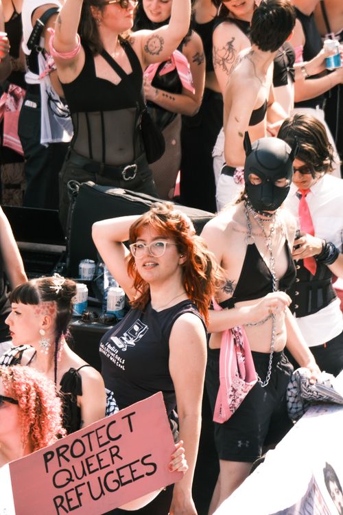 Free Diverse crowd celebrating at an LGBTQ+ pride parade in Amsterdam, Netherlands. Stock Photo