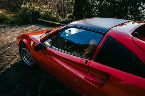 Free Stylish red Ferrari 328 GTS parked outdoors in Olgiasca, Lombardy, showcasing classic automotive design. Stock Photo
