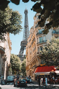 A picturesque Paris street scene featuring the Eiffel Tower with bustling cafes and people.