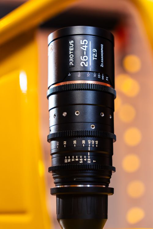 Free Detailed view of a cinema lens with engraved settings against a bright bokeh backdrop. Stock Photo