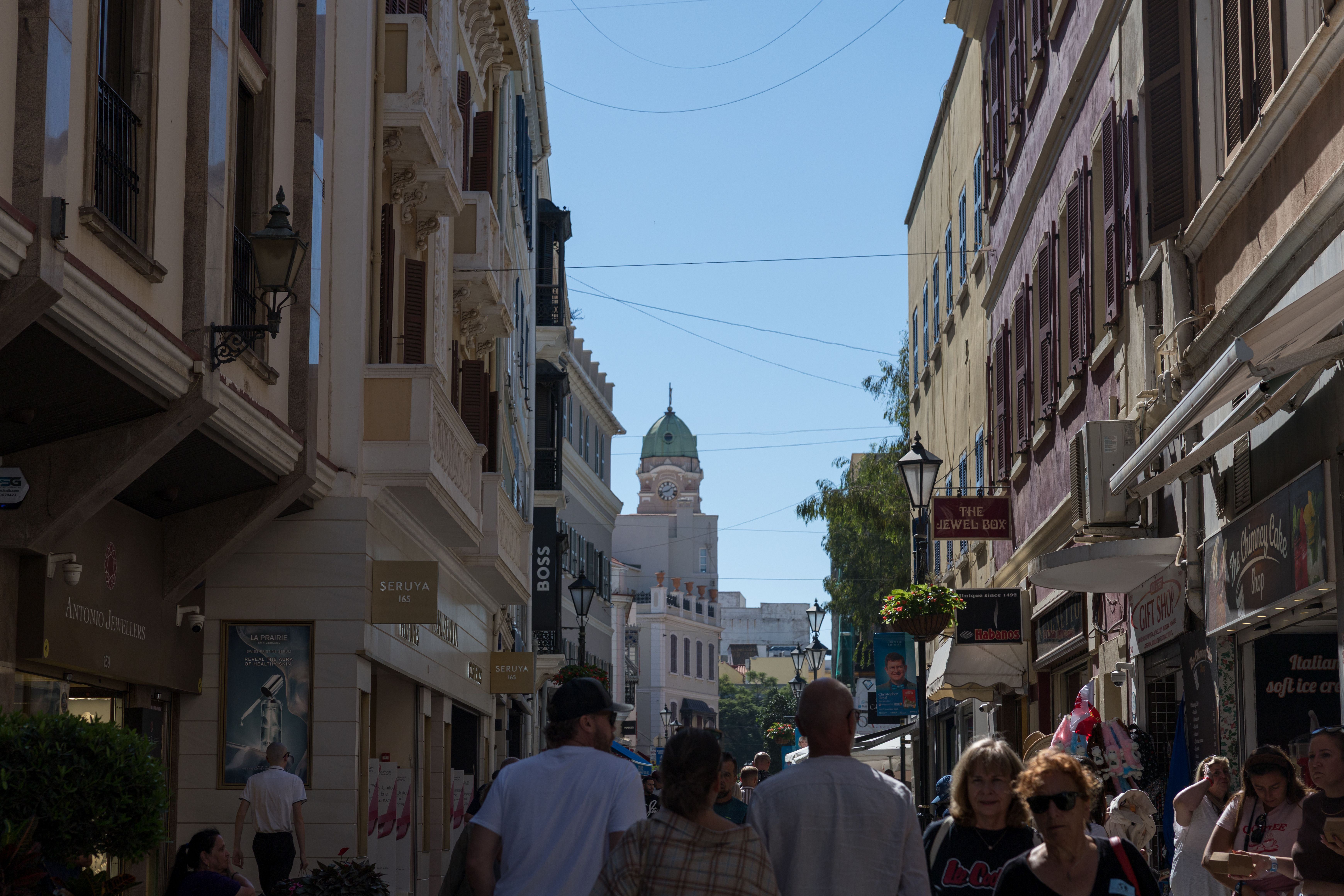 Bustling street life in Gibraltar featuring local architecture and shops in a lively ambiance.