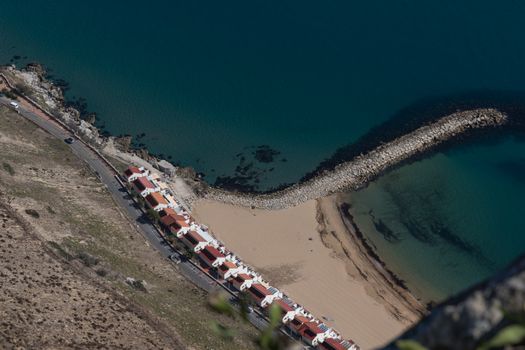 A breathtaking aerial shot of Gibraltar's coastline, featuring stunning beaches and vibrant blue waters.