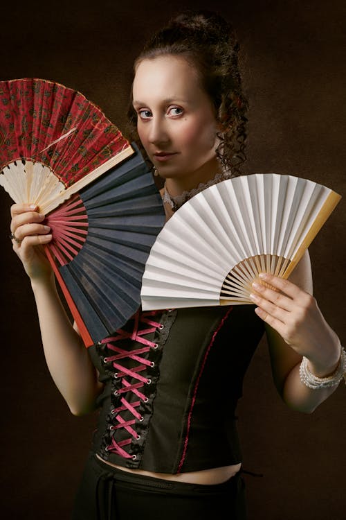 Woman Holding Two Hand Fans