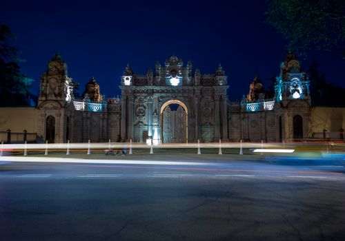 Free Night view of the illuminated ornate entrance of a historic Ottoman palace. Stock Photo