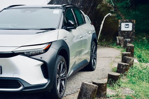 Sleek electric SUV navigating a winding mountain road, showcasing modern design and eco-friendly technology.