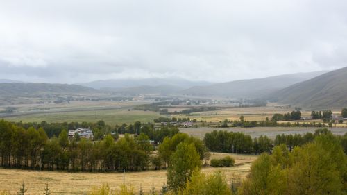 Free Panoramic view of a plateau landscape with rolling hills and autumn foliage under cloudy skies. Stock Photo