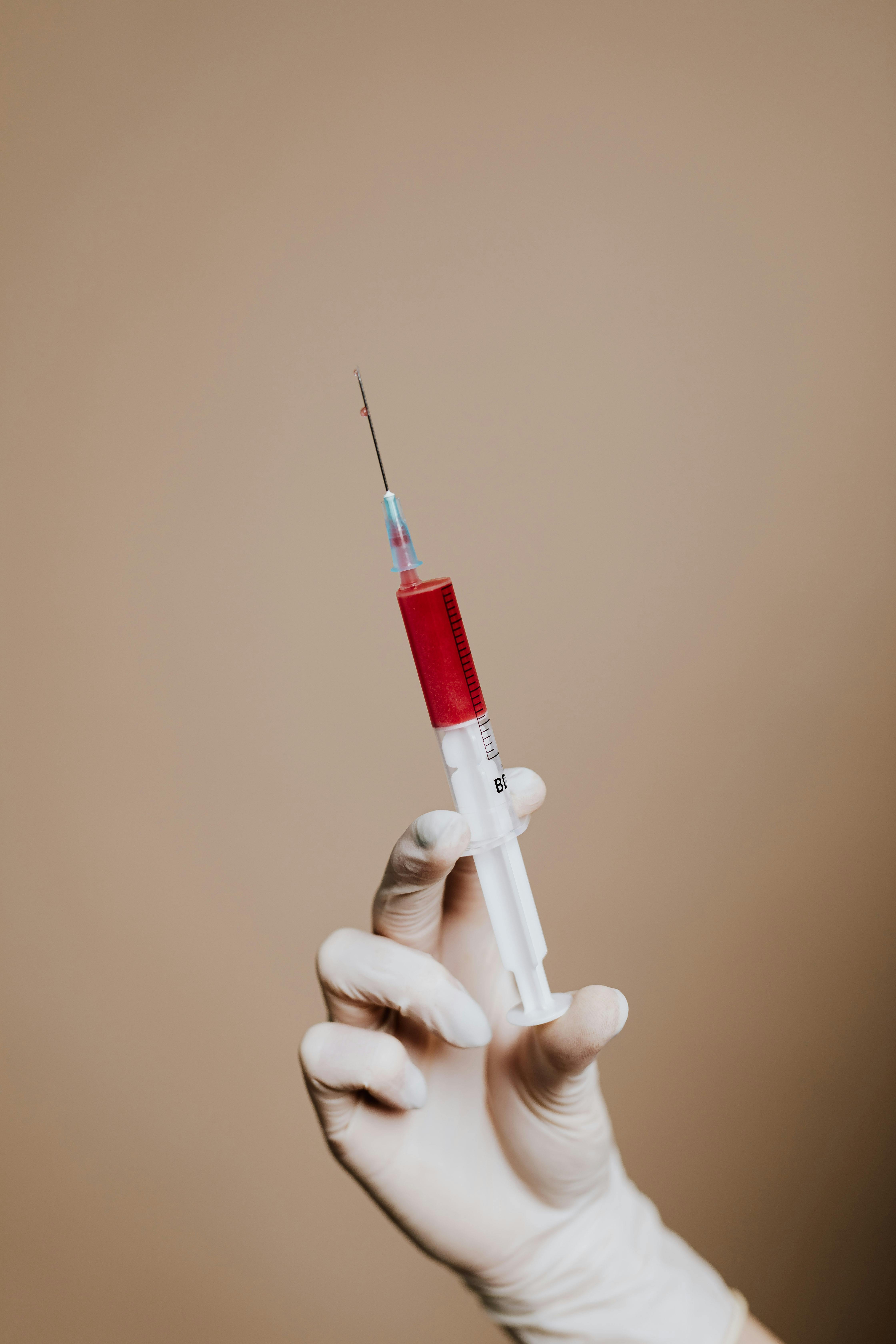 Photo Of Person Holding Syringe · Free Stock Photo