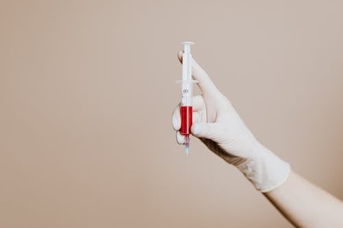 Photo Of Person Holding Syringe