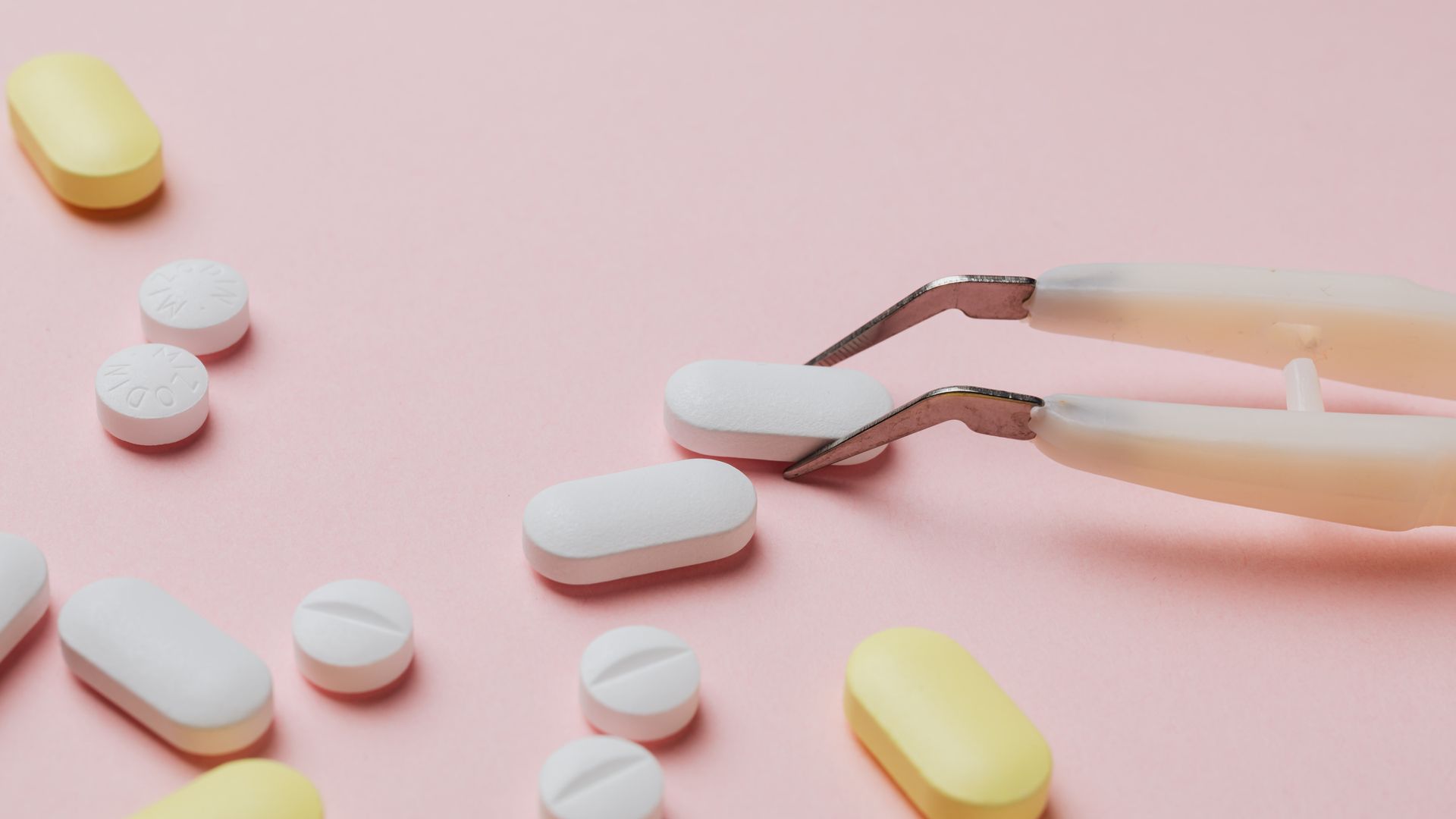 Can You Buy Modafinil Without Prescription? Understanding the Legalities Different pills and tablets on pastel pink background with tweezers — can you buy modafinil without prescription