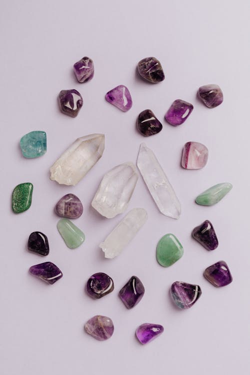 Free Set of colorful semiprecious stones placed chaotically on gray tabletop in jewelry store Stock Photo