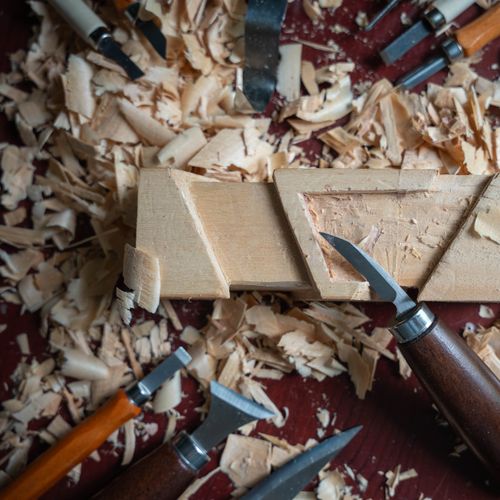Free Close-up of woodcarving tools and shavings, showcasing craftsmanship. Perfect for woodworking themes. Stock Photo