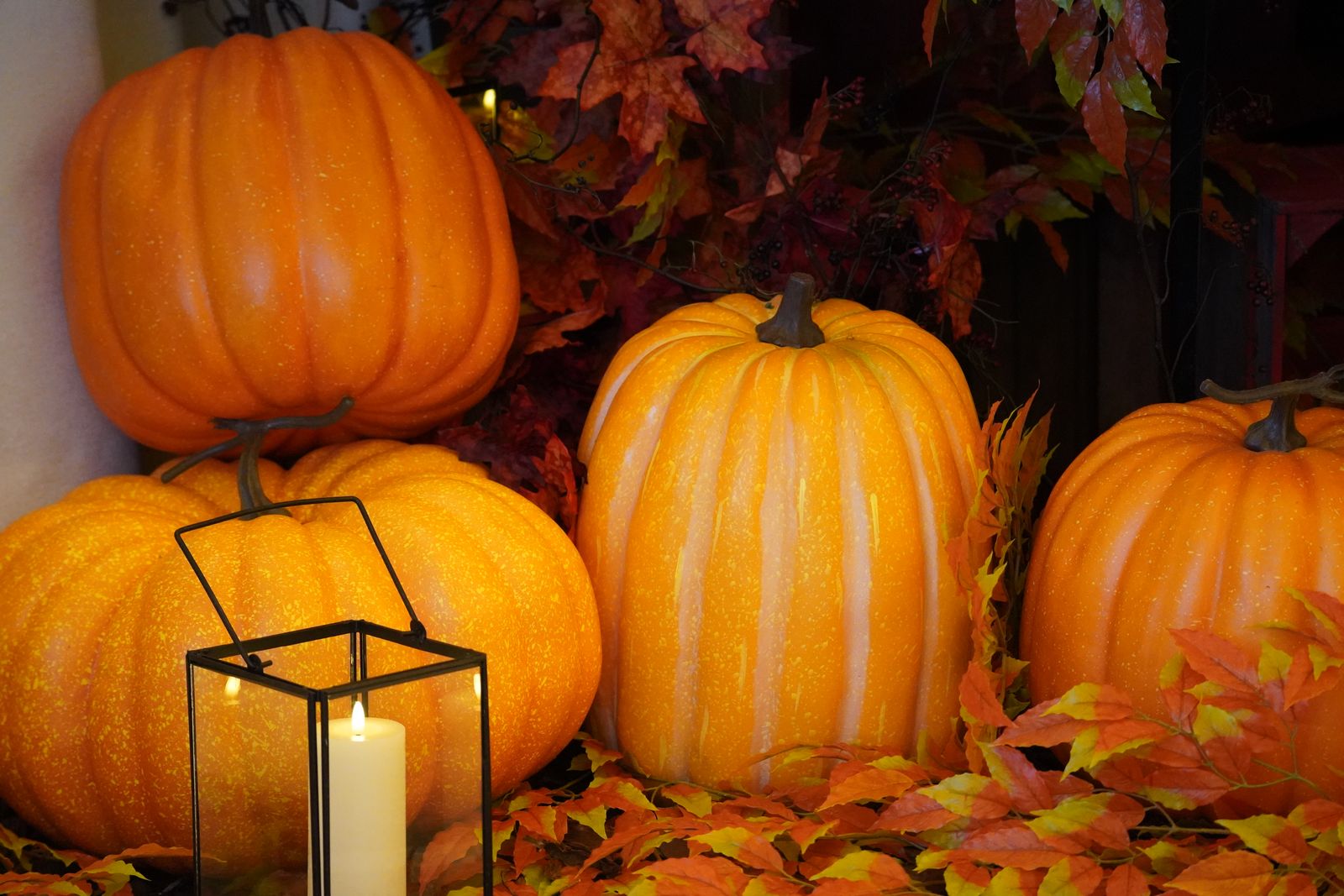 vibrant autumn display with pumpkins, a lantern, and colorful foliage, landscape
