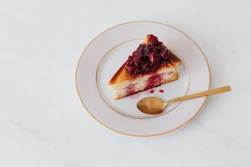 Tasty cheesecake on plate with spoon