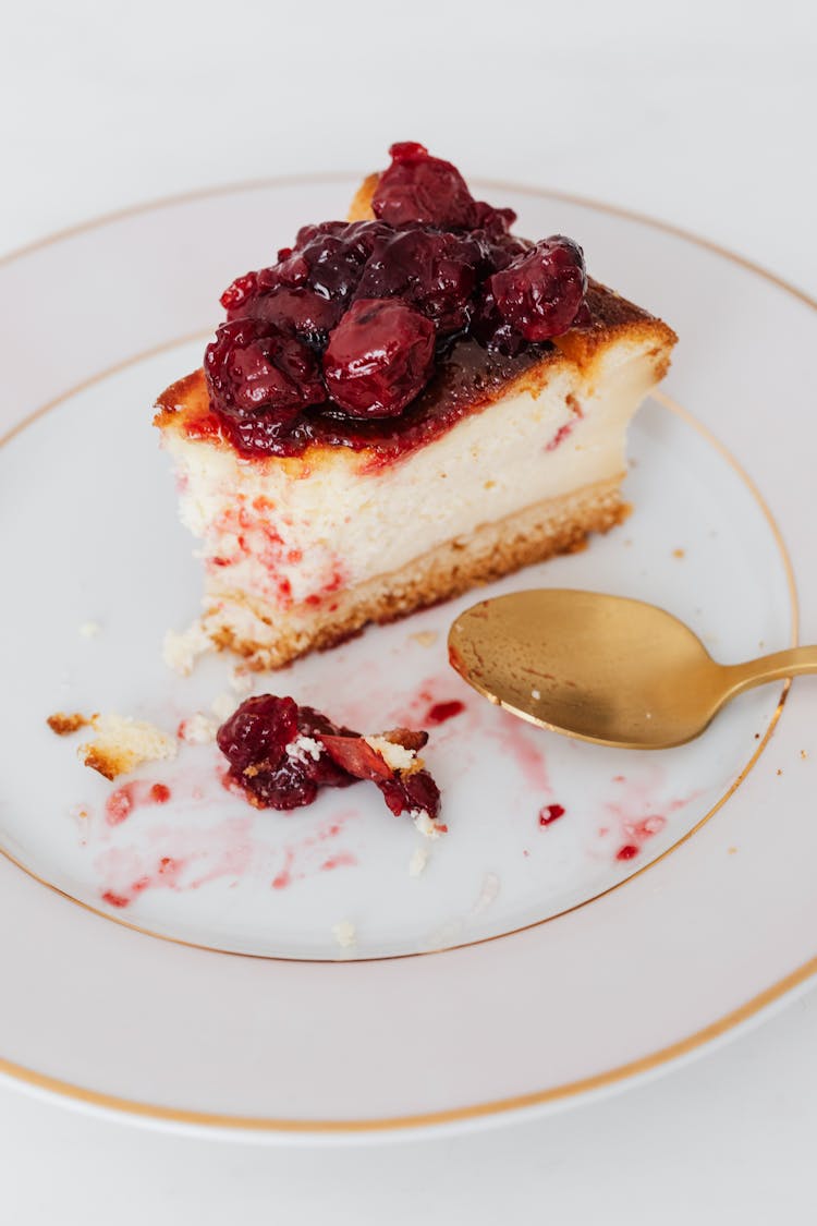 Bitten Piece Of Cherry Cheesecake On Plate