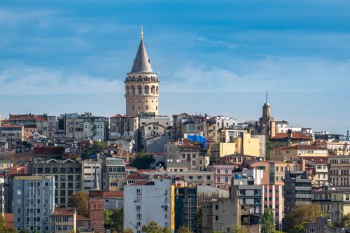Free A stunning view of Galata Tower amidst the vibrant Istanbul cityscape under a clear blue sky. Stock Photo
