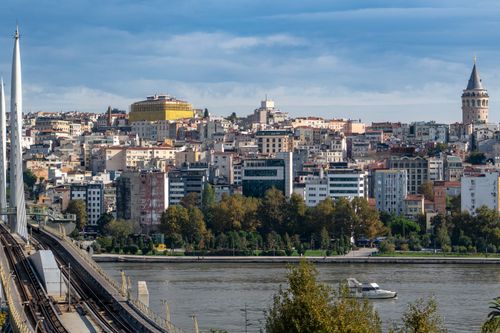 Free View of Istanbul featuring the iconic Galata Tower and urban skyline across the river. Stock Photo