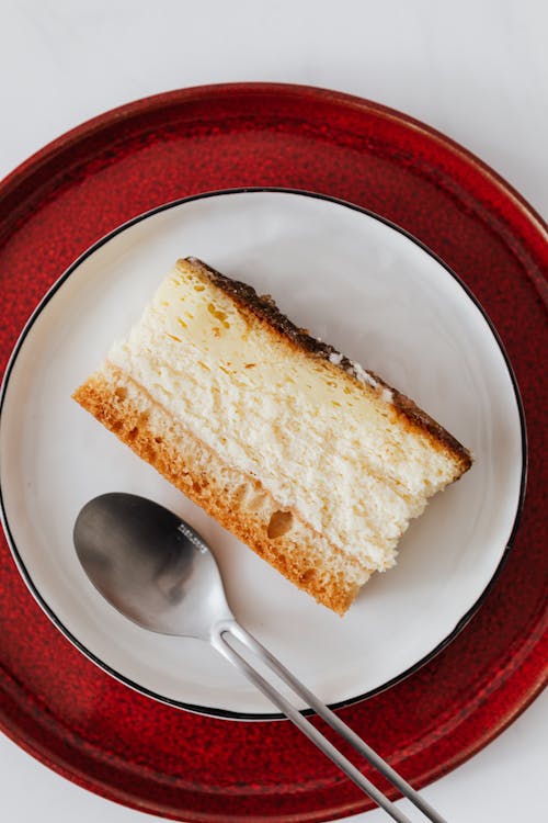 Appetizing dessert on plates with tea spoon