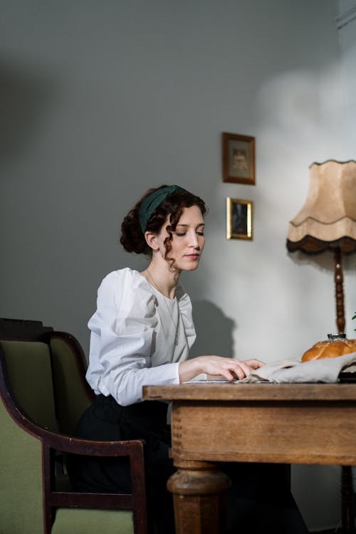 Woman Sitting at the Table