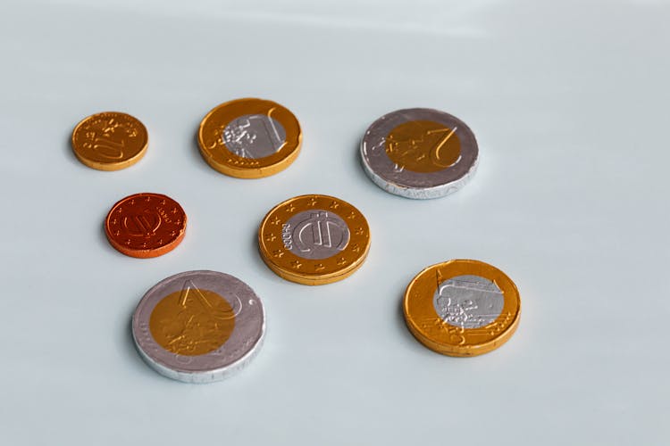 Chocolate Coins On White Surface