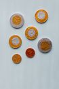 Top view of different size chocolate euro coins packed in foil and placed on white table