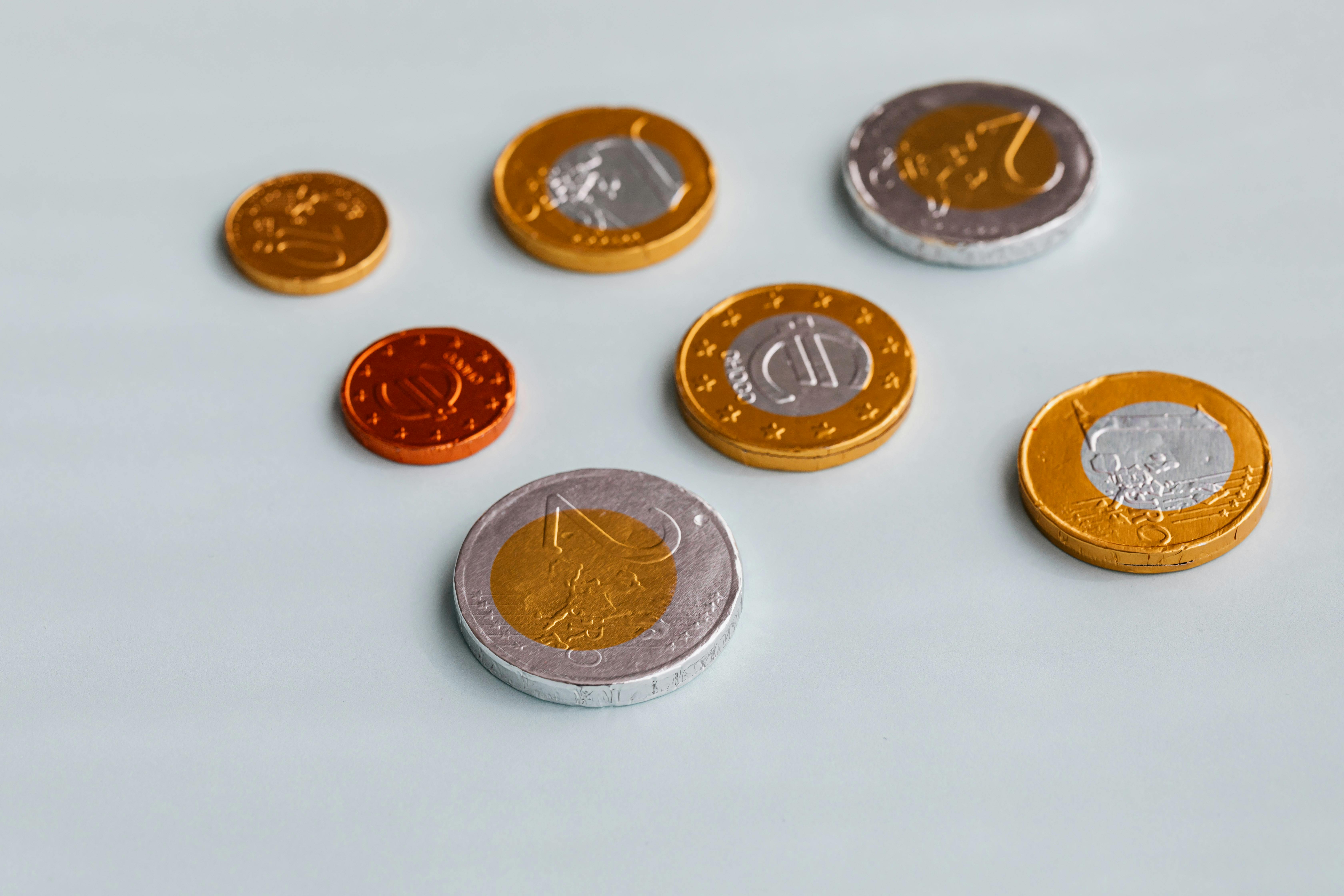 Set of chocolate euro coins on table by Karolina Grabowska