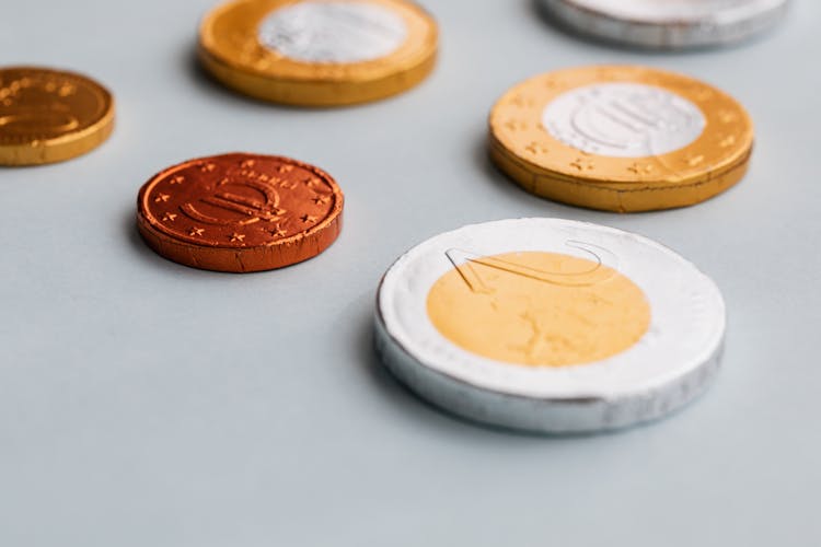 Chocolate Coins On White Surface