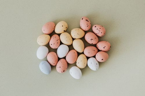 Free A collection of speckled pastel Easter eggs laid out on a smooth surface, ideal for holiday themes. Stock Photo